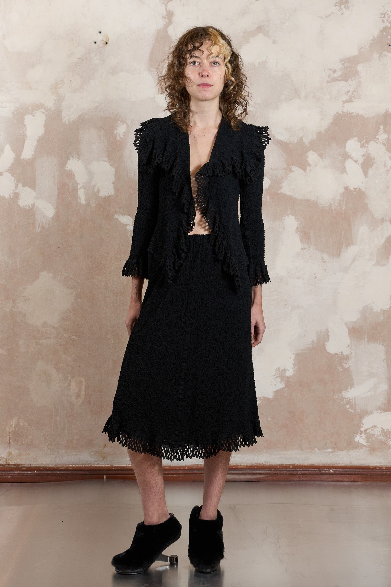 Rare blazer and skirt set tailored from black pleated fabric finished with doily ruffles 2008